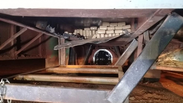 Os tabletes de maconha estavam escondidos no chassi e nas laterais do ônibus escolar — Foto: PM/Divulgação